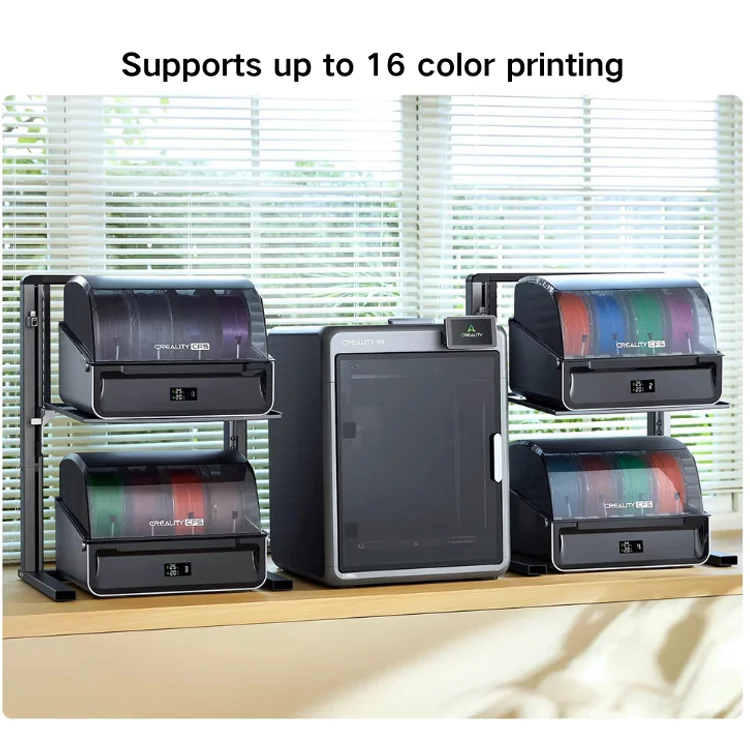 A desktop 3D printer setup with four color cartridges loaded into the printer racks, shown on a wooden shelf in front of window blinds. Text at the top reads 'Supports up to 16 color printing'.